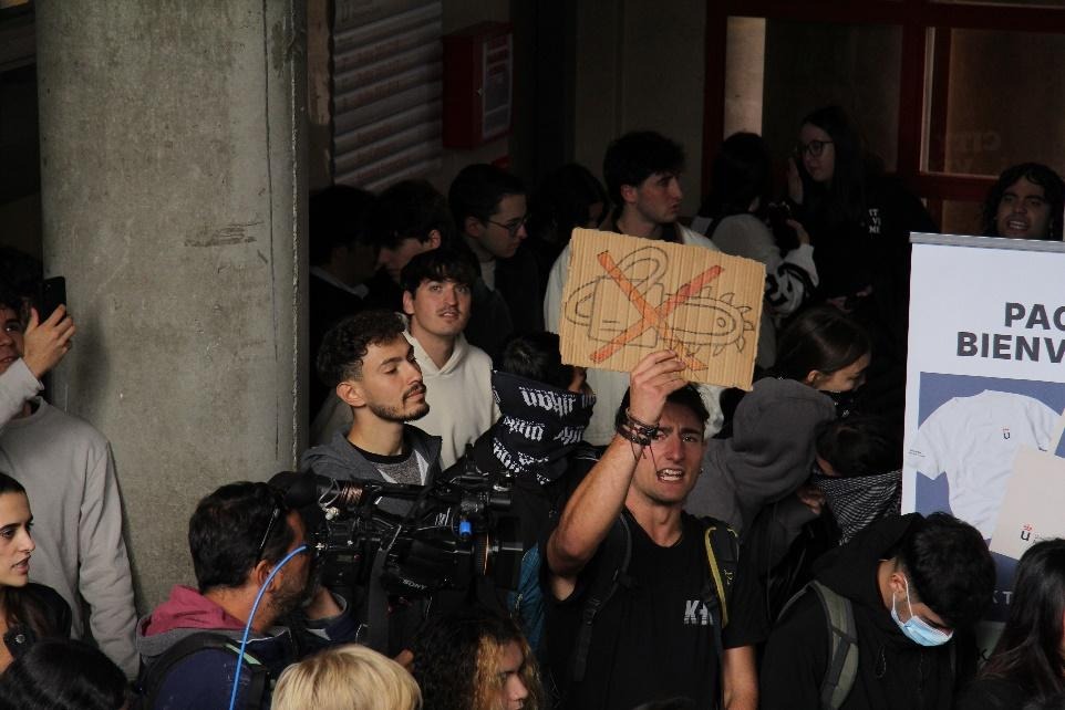 Un joven levanta una pancarta con una motosierra tachada durante la concentración | Firma:  Alejandro Arnautu 